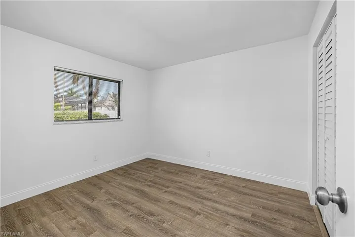 4012(R) Bedroom featuring new LVP light wood plank flooring and baseboards