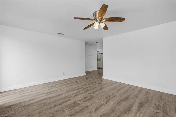 4012(R) Family room with light LVP wood plank floors and a ceiling fan