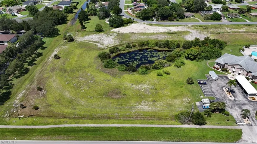 View of property location featuring a large body of water and nearby suburban area