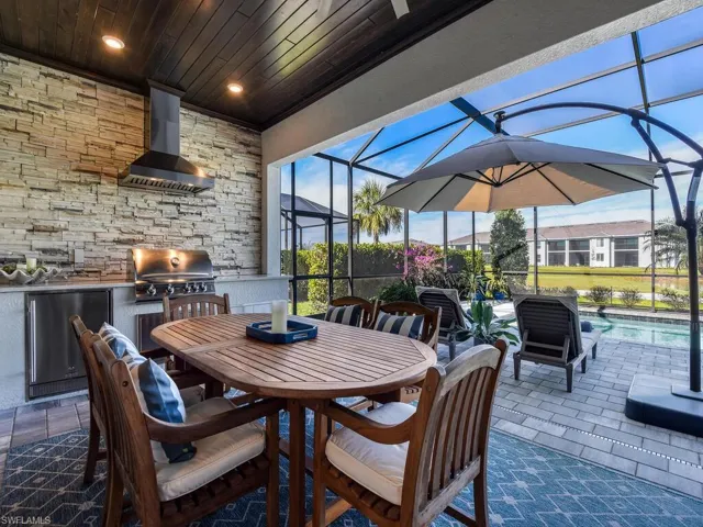 All season Lanai with outdoor kitchen, refrigerator and custom wood lanai ceiling
