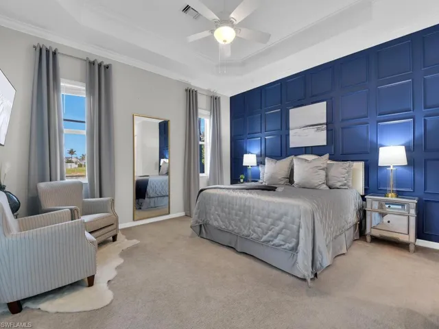 Expansive primary bedroom with custom drapes and feature wall