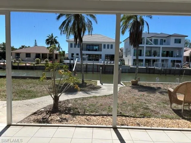 View of yard featuring a residential view and a water view