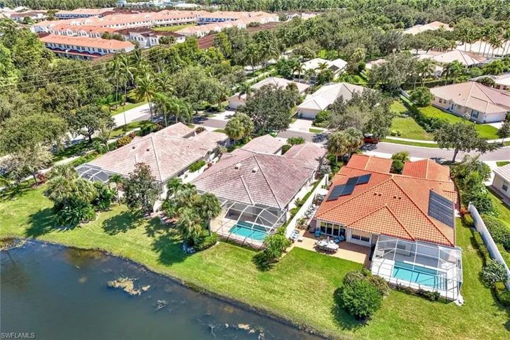 Property featuring a screened-in pool, waterside green space, tile roof, and solar panels
