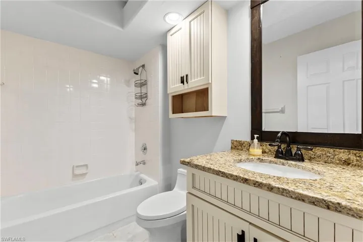 Bathroom with shower / bath combination and vanity