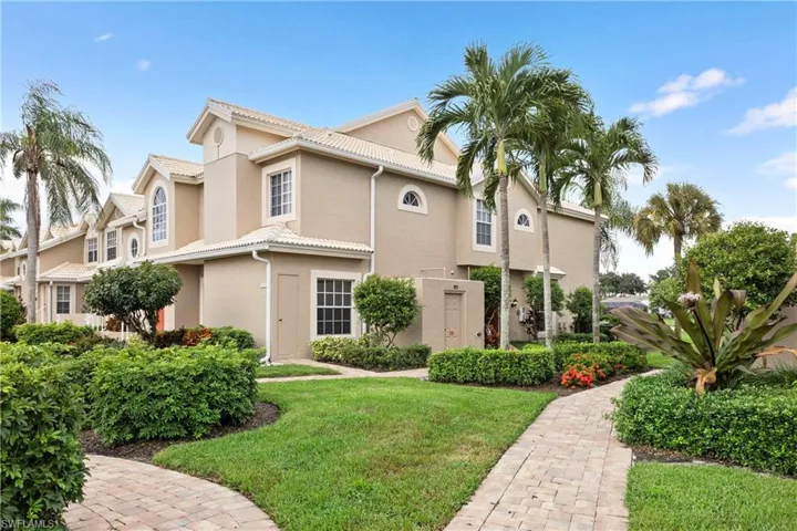 Mediterranean / spanish house featuring a front lawn, stucco siding, and a tiled roof