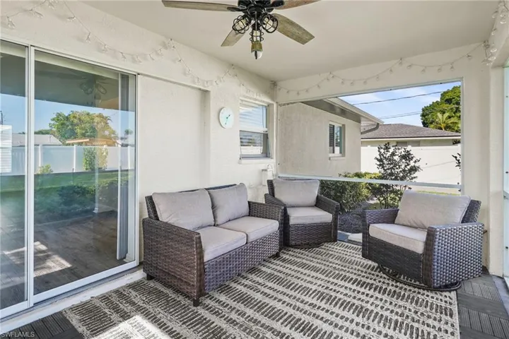 Back of house featuring stucco siding and a sunroom
