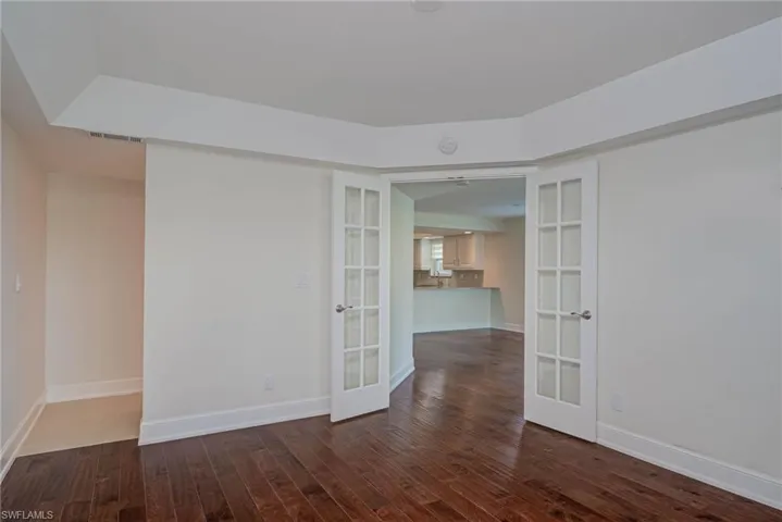 Primary bedroom w/ view to primary bath entry and main living space