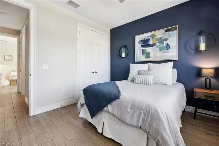 Bedroom with wood finish floors and a closet