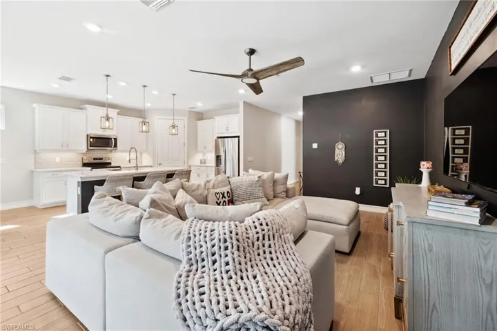 Living area featuring ceiling fan and light wood-type flooring