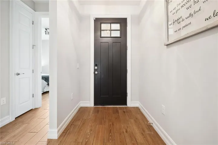 Entrance foyer featuring wood finished floors and baseboards