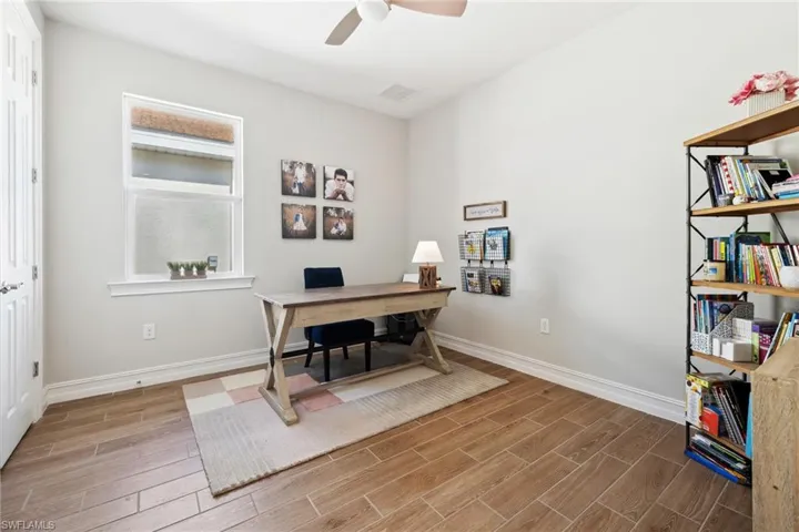 Office space featuring wood tiled floors and ceiling fan