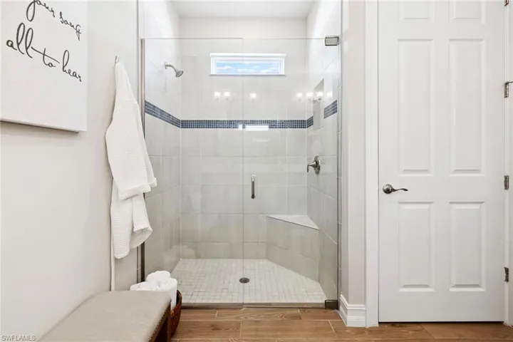 Full bathroom with a stall shower and wood finish floors