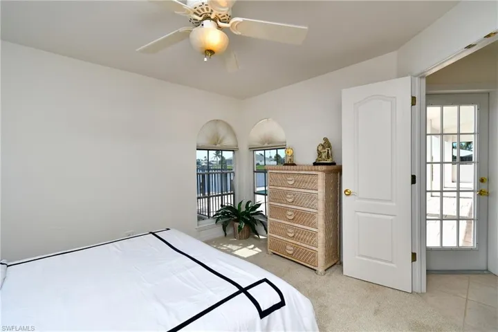 Bedroom featuring light carpet and ceiling fan