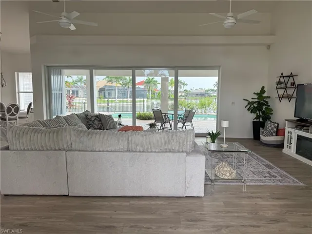 Living room featuring ceiling fan and wood finished floors