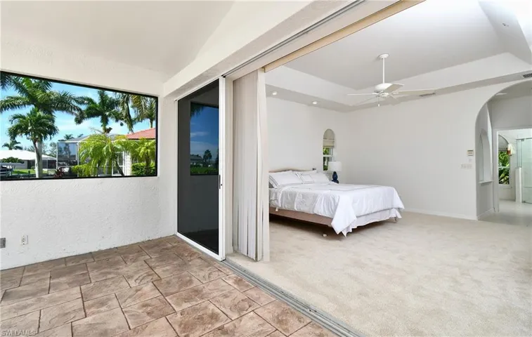 Carpeted bedroom featuring ceiling fan