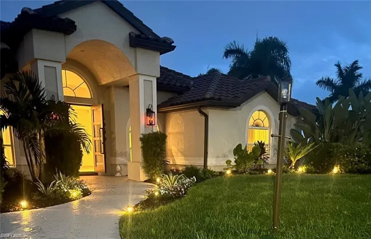 Mediterranean / spanish house featuring stucco siding, a front yard, and a tile roof