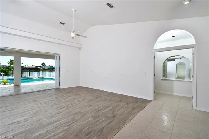 Spare room with high vaulted ceiling, light hardwood / wood-style flooring, and ceiling fan