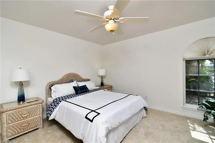 Bedroom featuring ceiling fan and light colored carpet