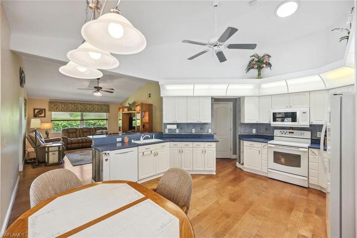 Kitchen overlooks family room - counter top in family room with bar stools!