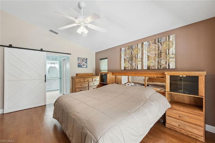 Custom barn door leads to bathroom and TWO walk in closets!