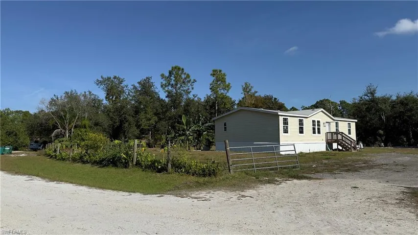 View of home's exterior with view of scattered trees