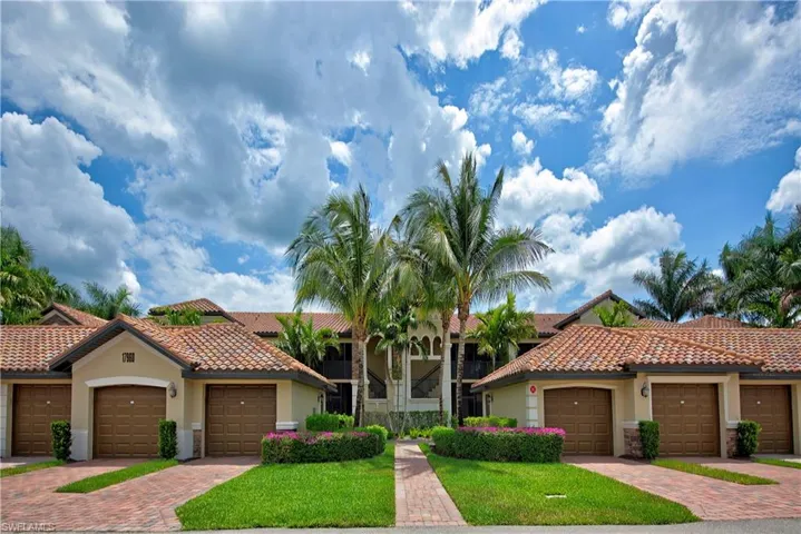 Mediterranean / spanish house featuring a front lawn and a garage