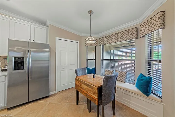 Tiled dining room with crown molding