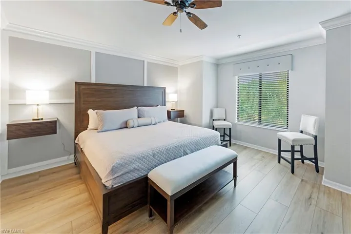 Bedroom featuring light wood-type flooring, ceiling fan, and crown molding