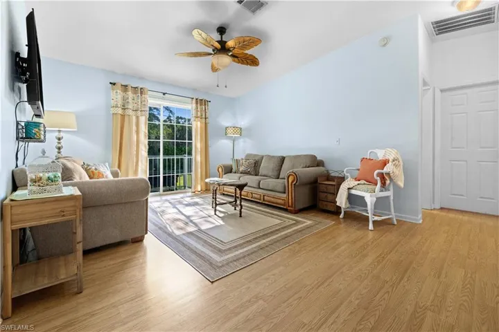 Living area featuring light wood-style flooring and a ceiling fan
