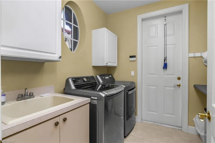 Utility room, laundry tub, cabinet above and below. Washer and dryer convey with purchase.