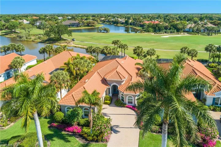 Aerial view of front and back...note Royal Palms on both sides of driveway...back faces unobstructed view of #6 fairway of Club's south course, large lake to left and another in distance.