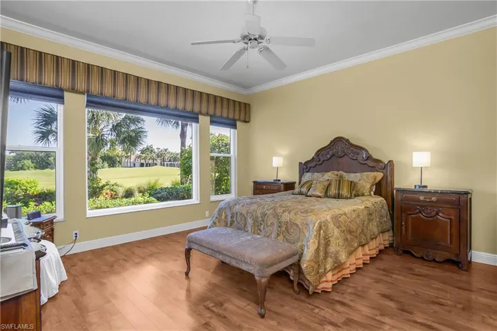 Large master bedroom with custom hurricane impact windows and one very large fixed window with view to the back. A full pull down shade provides privacy and complete darkness. Wood flooring, no carpet in the house.