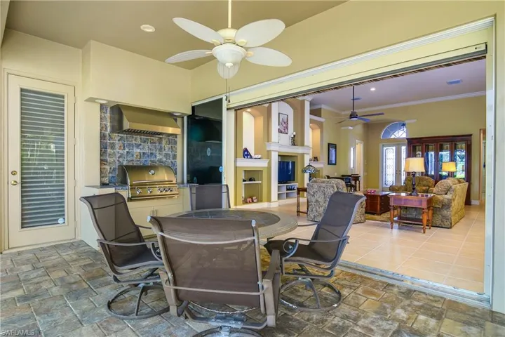 Lanai dining area...note there is a screen at top of sliders, electrically powered, to keep insects out from house while sliders are fully open for ventilation.