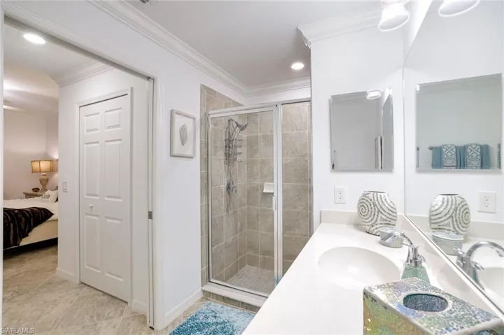 Bathroom featuring vanity, ensuite bathroom, a shower stall, ornamental molding, and recessed lighting