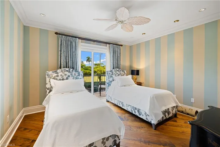 Bedroom featuring an ensuite bath, crown molding, a ceiling fan, recessed lighting, and wood flooring