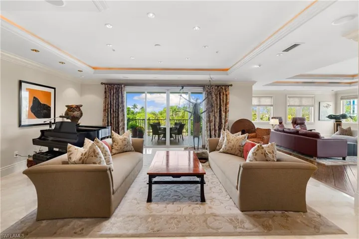 Expansive living area featuring recessed lighting, crown molding, and marble floors with an fantastic view.