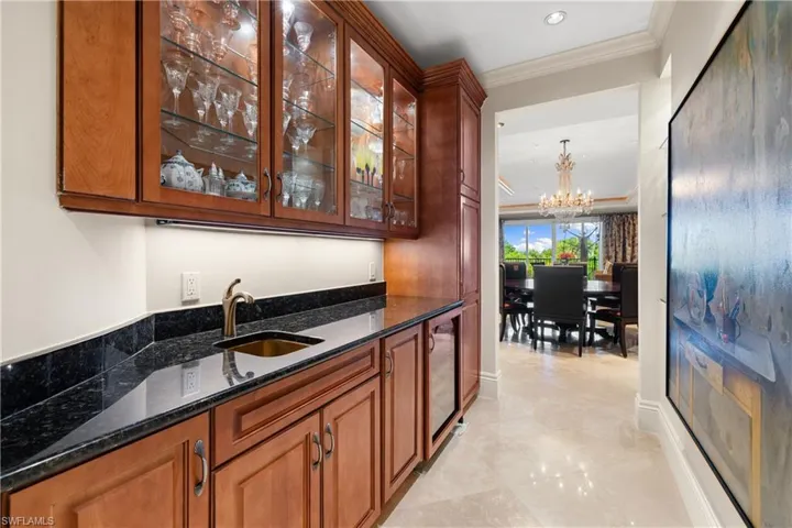 The entertainment center includes a wine refrigerator.