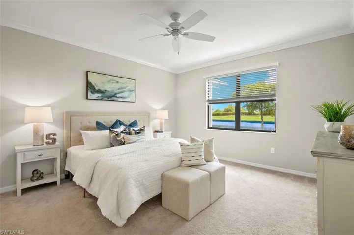 Bedroom featuring crown molding, ceiling fan, and light colored carpet