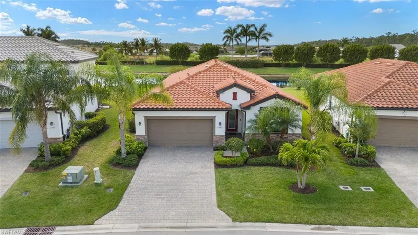 Mediterranean / spanish-style house featuring a garage and a front yard