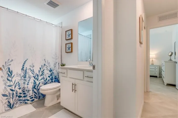 Bathroom featuring tile patterned floors, vanity, and toilet