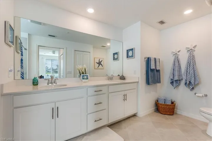 Bathroom with tile patterned floors, vanity, and toilet