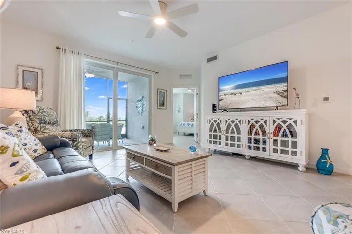 Living room featuring ceiling fan and light tile patterned floors