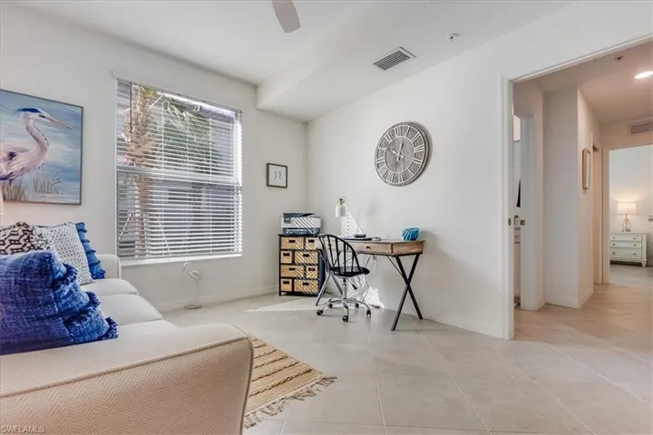 Home office featuring ceiling fan and light tile patterned floors