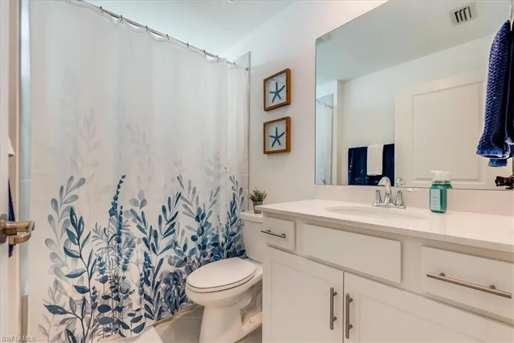 Bathroom featuring tile patterned floors, vanity, and toilet