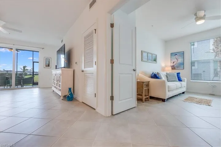 Hallway with light tile patterned flooring