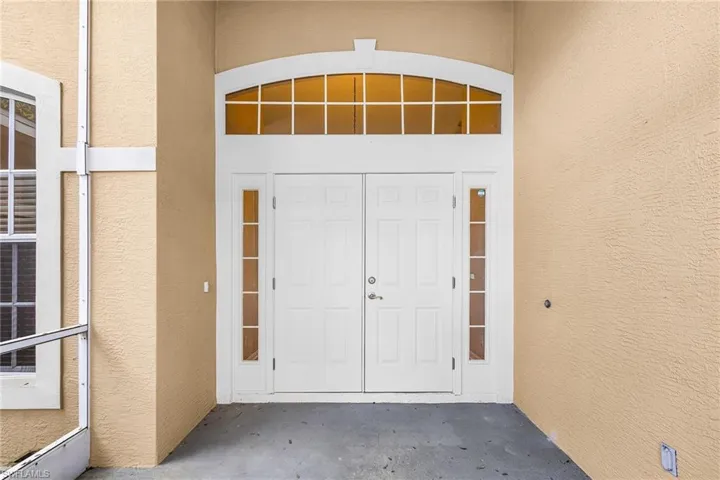 Property entrance with stucco siding