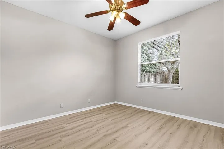 Spare room with a ceiling fan and light wood finished floors