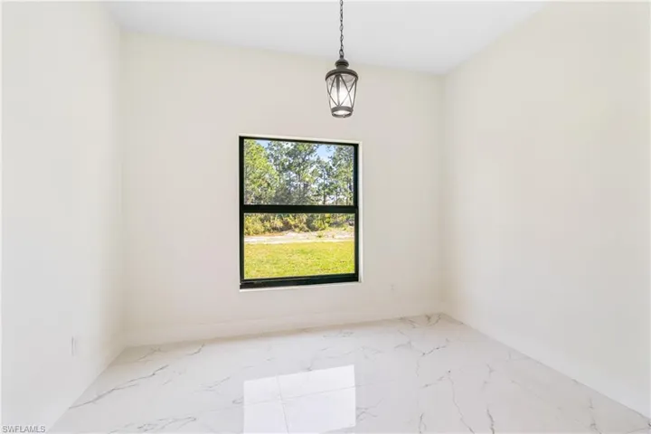 Empty room featuring light marble finish floors