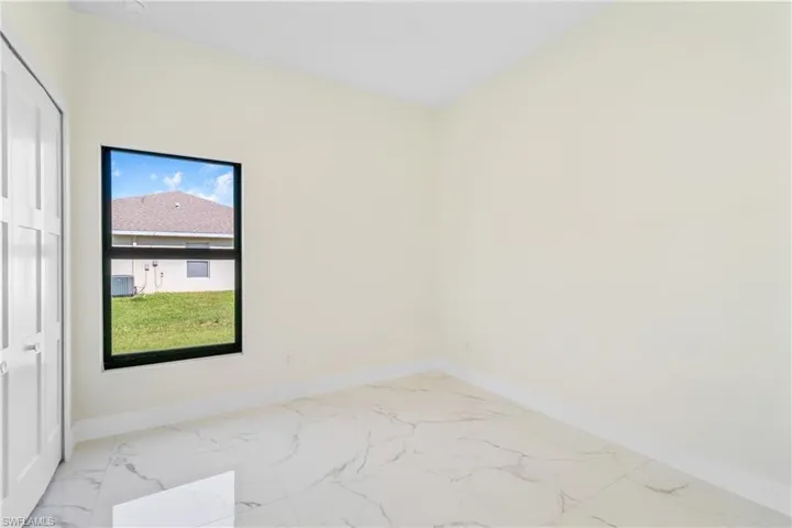Empty room with light marble finish floors and baseboards