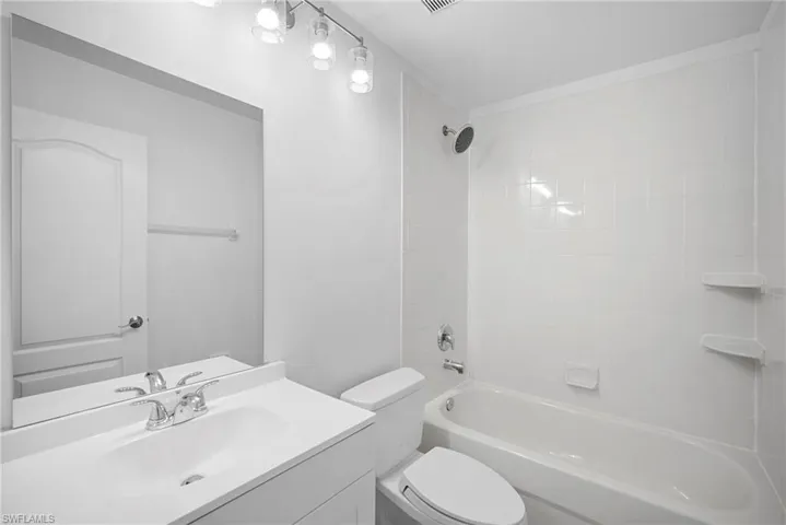 Full bathroom with vanity and washtub / shower combination